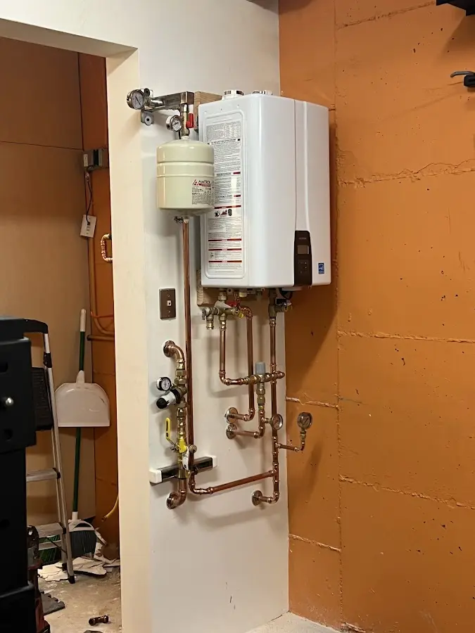 Plumbing technician inspecting water heater connections in Yorba Linda